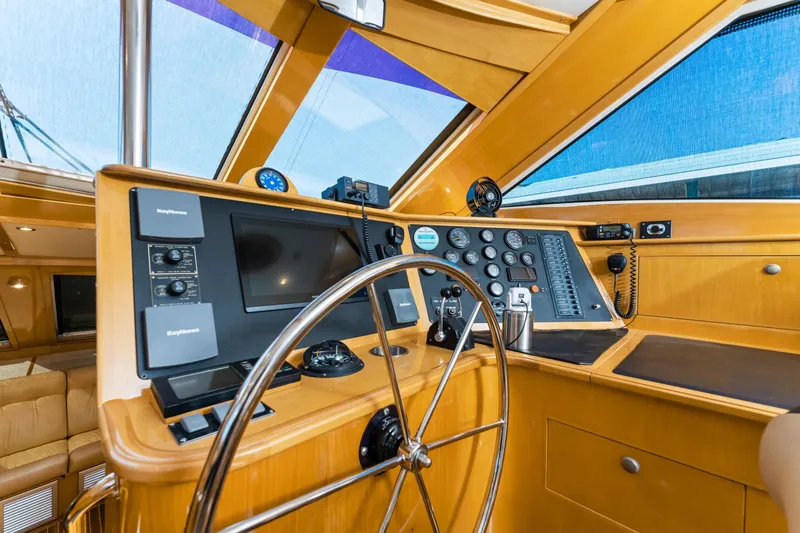 Slide: The Image of Helm of 2000 Jutson 46 LRC yacht with navigation instruments and steering wheel. - 34