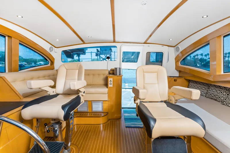 Slide: The Image of Luxurious interior of 2000 Jutson 46 LRC yacht with plush seating and panoramic windows. - 43