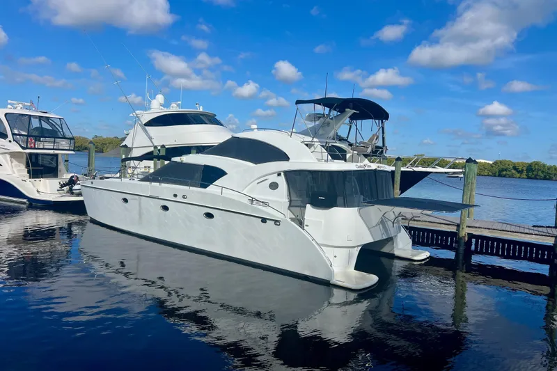 Slide: The Image of Luxury 2000 Jutson 46 LRC yacht docked under blue sky. - 9