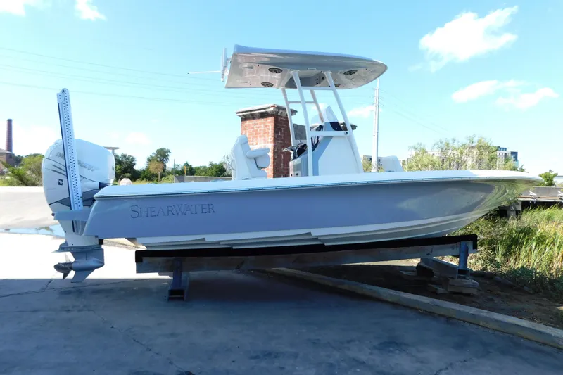 The Image of 2022 ShearWater 250 XTE boat on trailer, side view, clear sky background. - 0