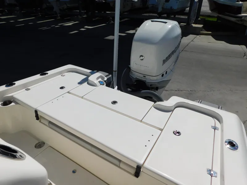 Slide: The Image of 2022 ShearWater 250 XTE boat with outboard motor, docked on a sunny day. - 11