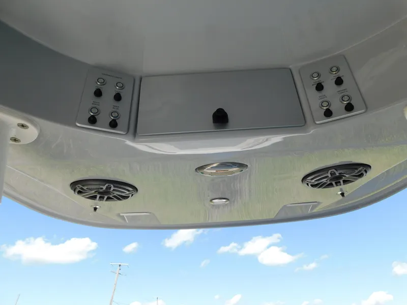 Slide: The Image of 2022 ShearWater 250 XTE boat console with speakers and controls against blue sky. - 15