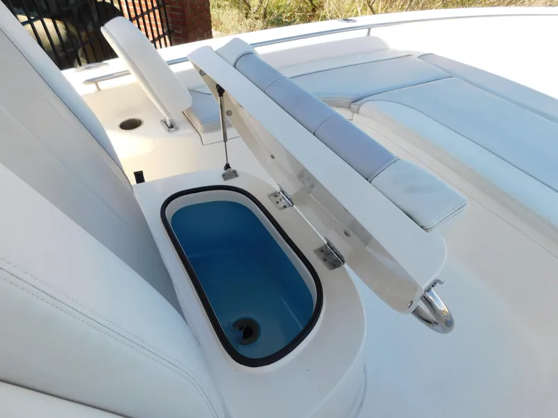 Slide: The Image of 2022 ShearWater 250 XTE boat with open storage compartment and cushioned seating. - 21