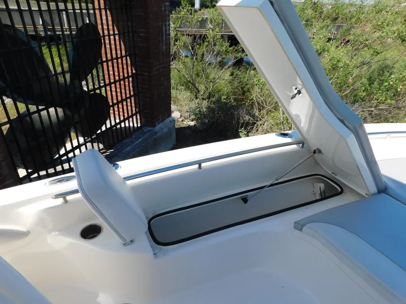 Slide: The Image of 2022 ShearWater 250 XTE boat storage compartment open, showcasing spacious interior. - 22