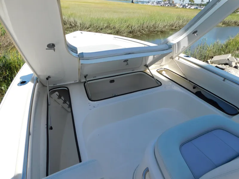 Slide: The Image of 2022 ShearWater 250 XTE boat interior with open storage compartments. - 25