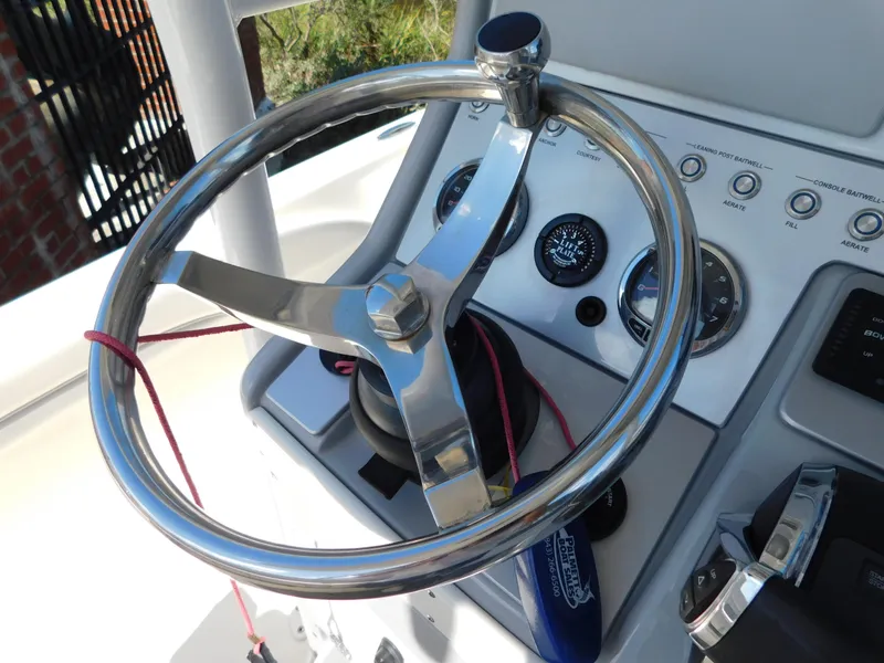 Slide: The Image of Steering wheel of 2022 ShearWater 250 XTE boat with control panel. - 35