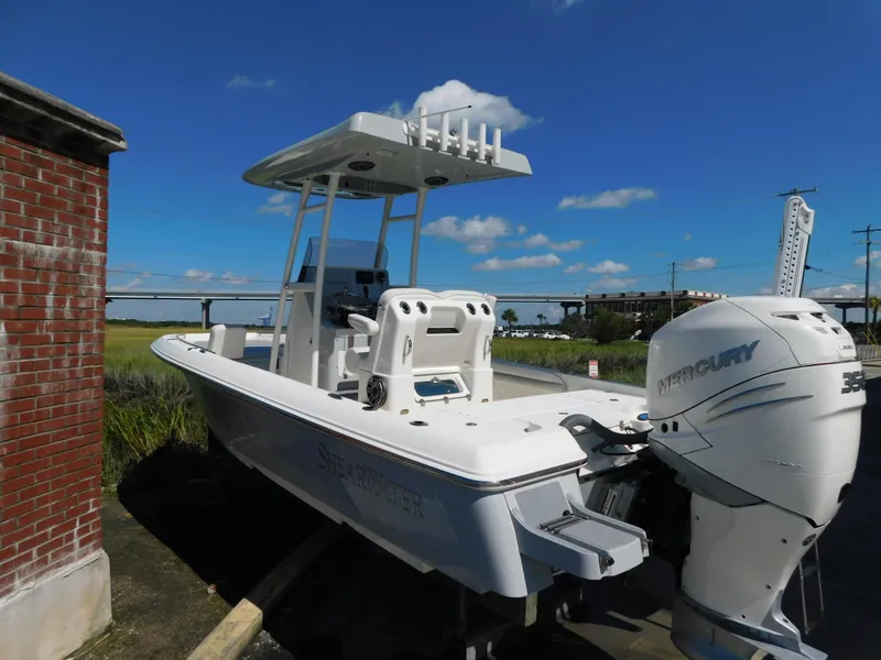 Slide: The Image of 2022 ShearWater 250 XTE boat with Mercury engine, docked under clear blue sky. - 43