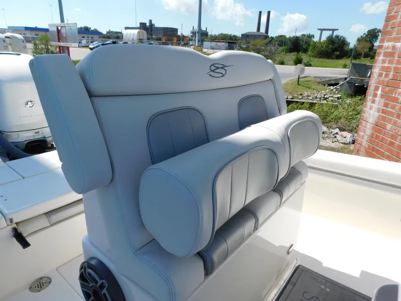 Slide: The Image of ShearWater 250 XTE 2022 boat seat with gray upholstery and logo. - 7