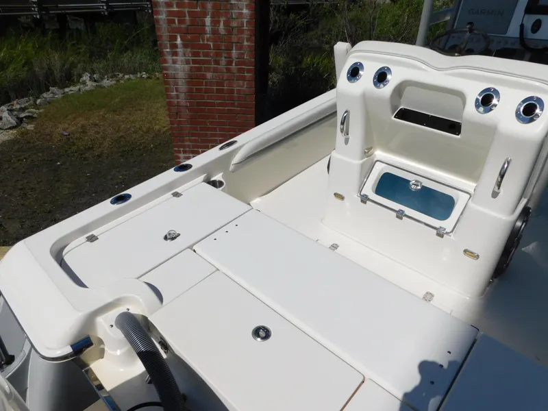 Slide: The Image of 2022 ShearWater 250 XTE boat deck with storage compartments and seating area. - 9