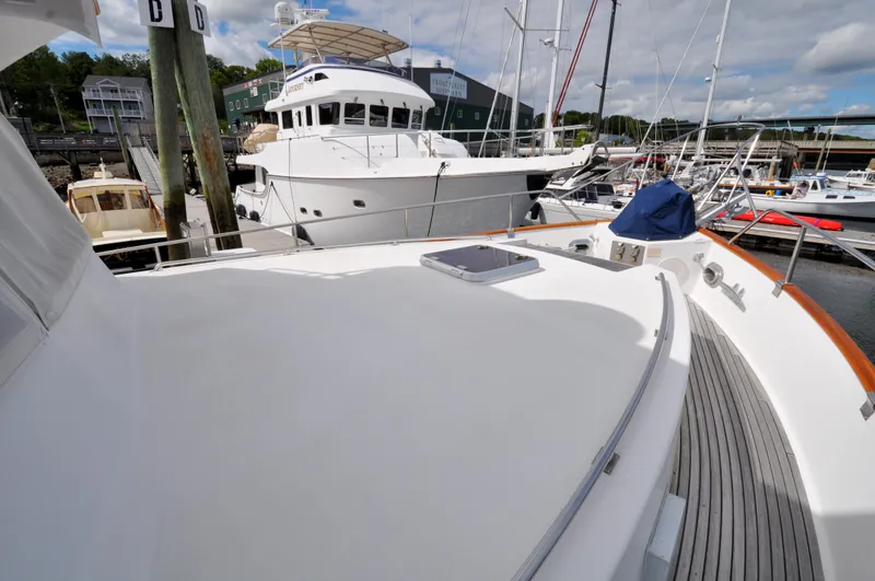 Slide: The Image of Grand Banks Heritage Europa 52 yacht docked at marina, showcasing spacious deck, 2000 model. - 11