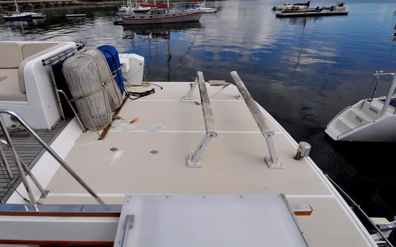 Slide: The Image of Grand Banks Heritage Europa 52 yacht deck, 2000 model, docked with calm water reflections. - 16