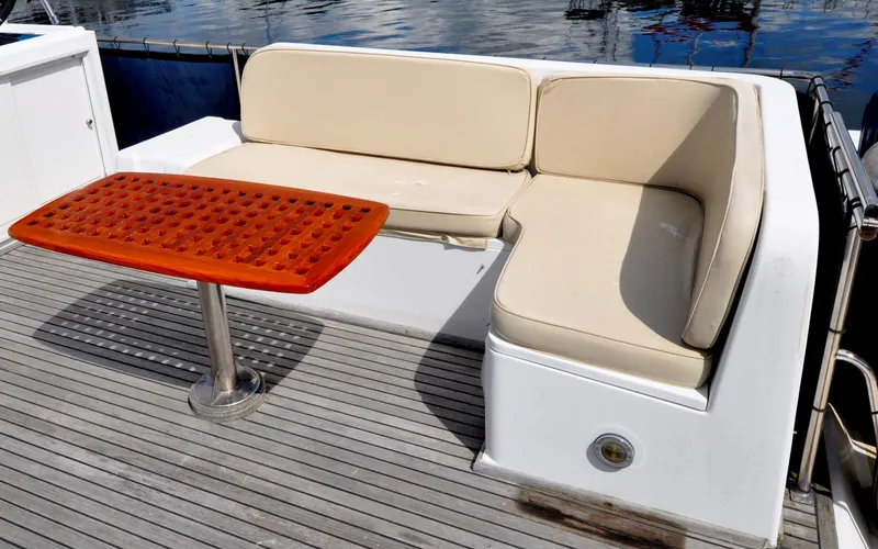 Slide: The Image of Outdoor seating area on a 2000 Grand Banks Heritage Europa 52 yacht with a wooden table. - 22