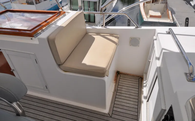Slide: The Image of Grand Banks Heritage Europa 52, 2000 model, featuring a cushioned seating area on deck. - 28