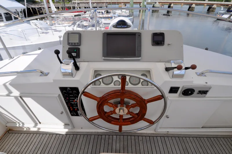 Slide: The Image of Helm of 2000 Grand Banks Heritage Europa 52 yacht with wooden wheel and navigation equipment. - 29