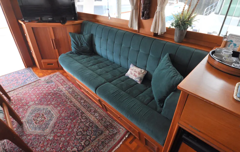 Slide: The Image of Luxurious interior of 2000 Grand Banks Heritage Europa 52 with plush green sofa and elegant decor. - 43