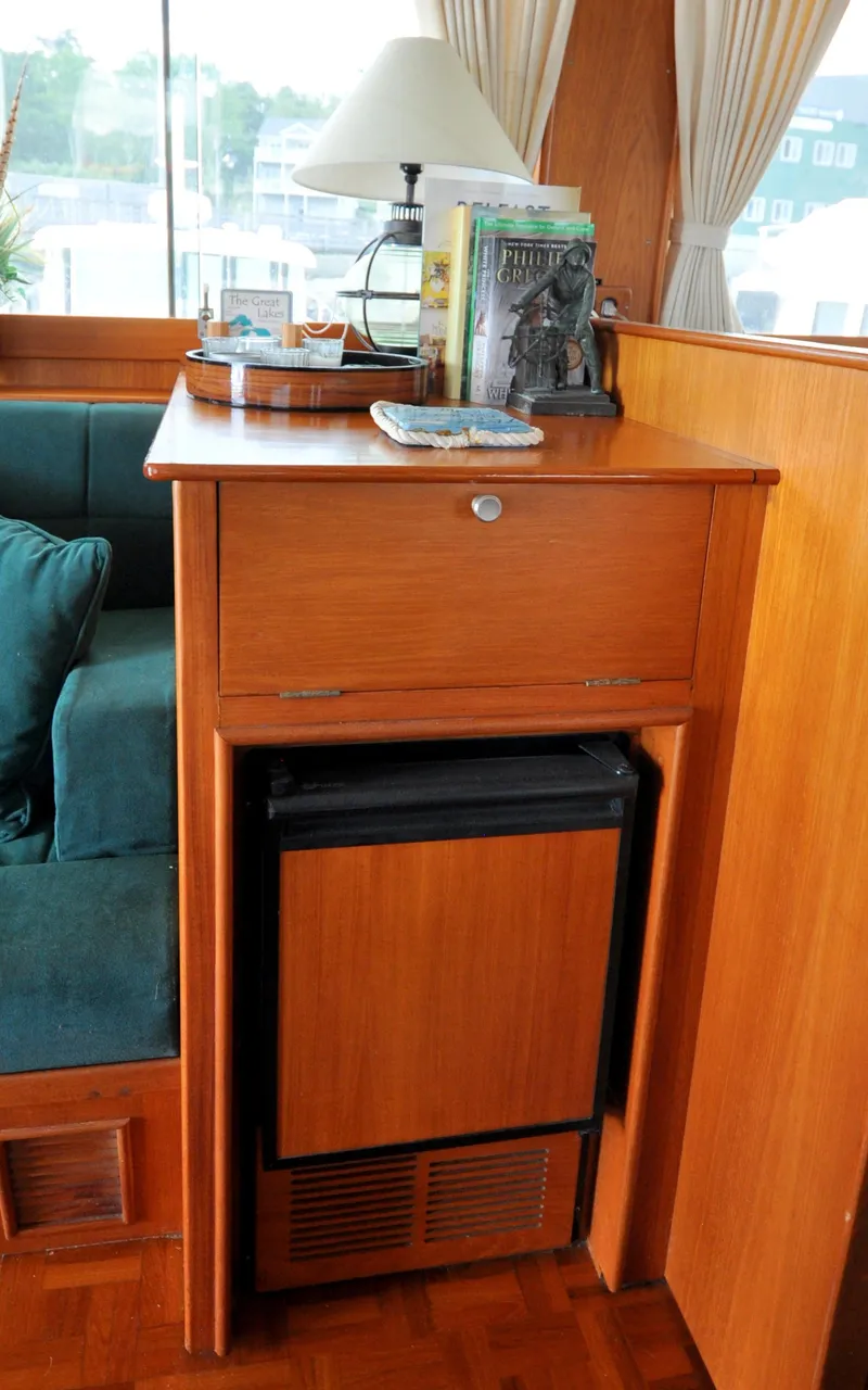 Slide: The Image of Interior of 2000 Grand Banks Heritage Europa 52 with wooden cabinetry and mini-fridge. - 44