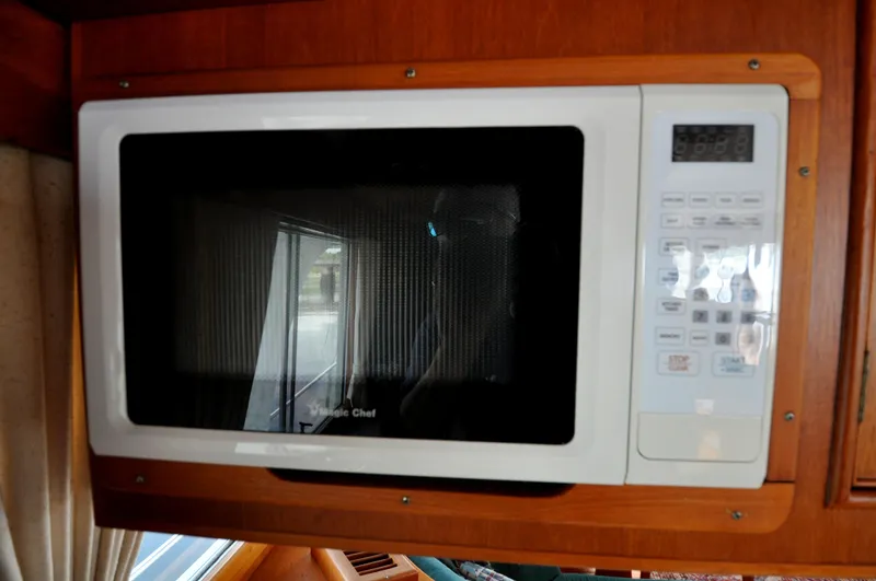 Slide: The Image of Microwave oven inside a 2000 Grand Banks Heritage Europa 52 yacht kitchen. - 49