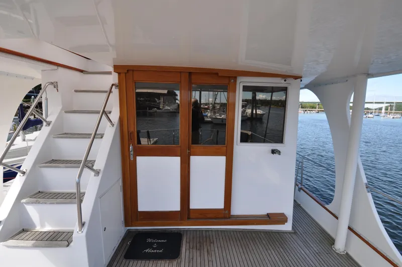 Slide: The Image of Grand Banks Heritage Europa 52 yacht deck with wooden doors and staircase, 2000 model. - 9