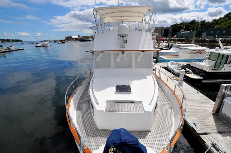 Slide: The Image of Grand Banks Heritage Europa 52 yacht docked at a marina, 2000 model, with clear skies. - 15