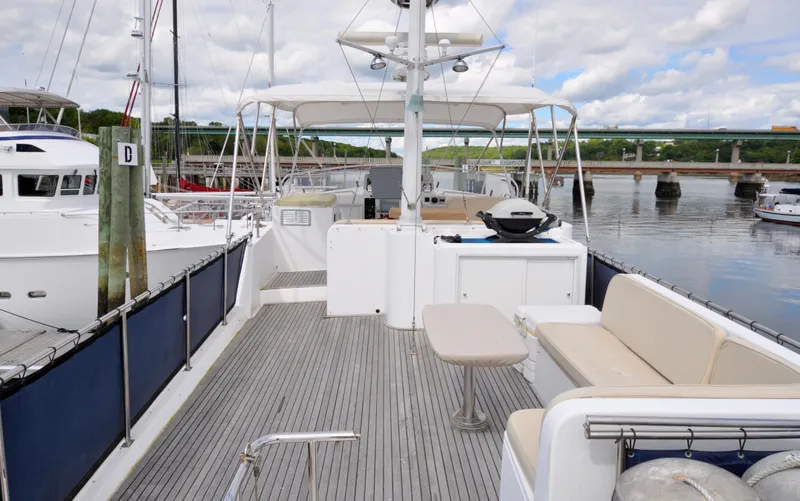 Slide: The Image of Grand Banks Heritage Europa 52 yacht deck, 2000 model, docked at a marina with scenic views. - 20