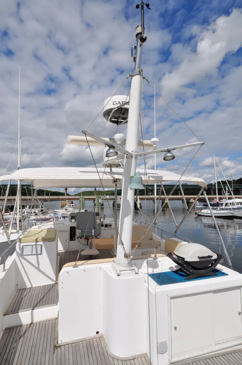 Slide: The Image of Grand Banks Heritage Europa 52 yacht deck, 2000 model, docked at marina under cloudy sky. - 24