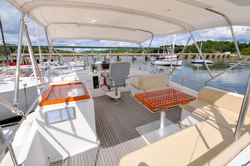 Slide: The Image of Flybridge of 2000 Grand Banks Heritage Europa 52 yacht with seating and helm station. - 25