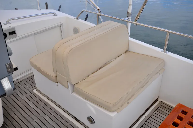 Slide: The Image of Grand Banks Heritage Europa 52, 2000 model, beige cushioned seating on deck. - 26