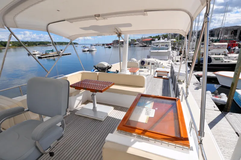 Slide: The Image of Flybridge of 2000 Grand Banks Heritage Europa 52 yacht docked at marina. - 39