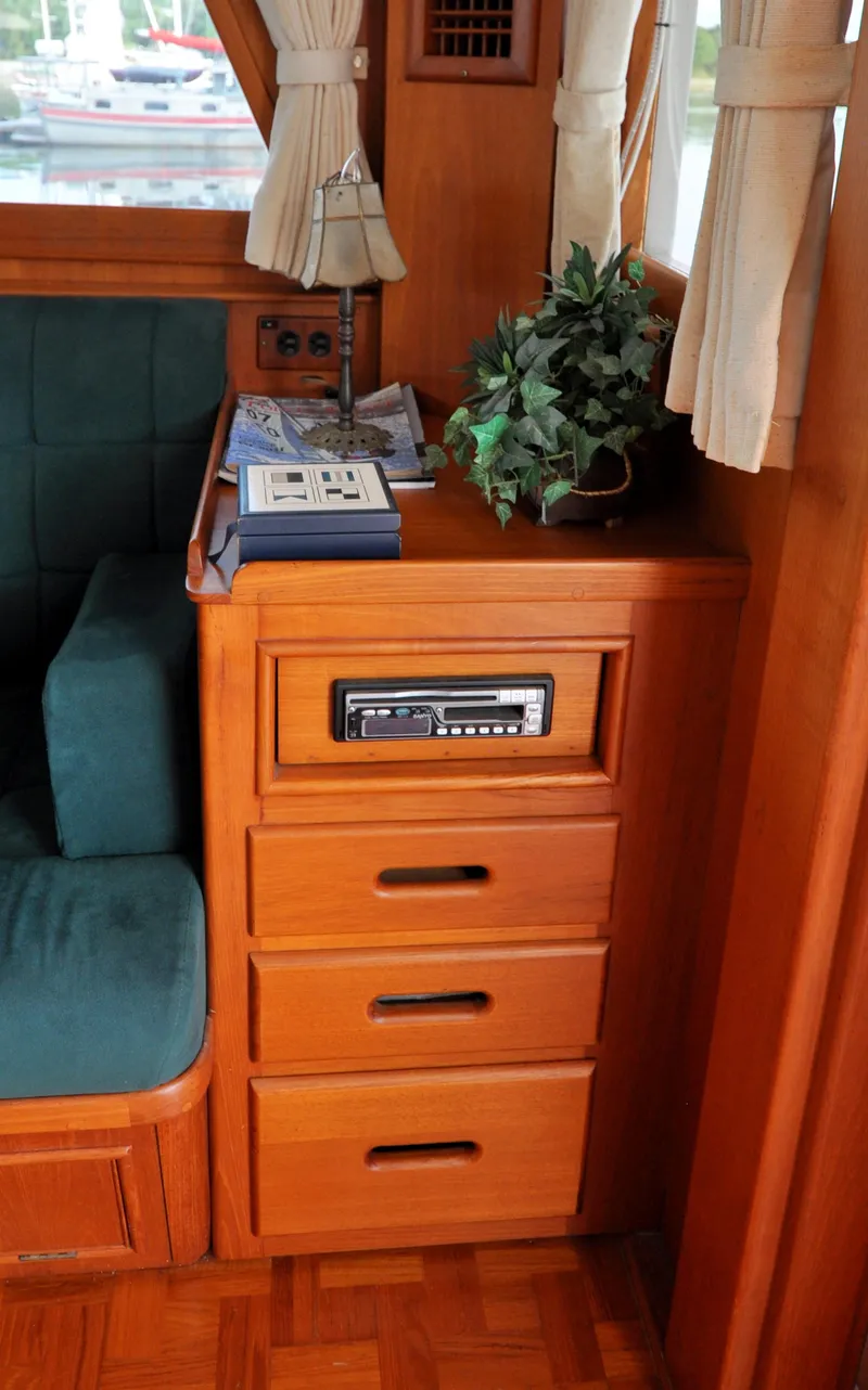 Slide: The Image of Interior of 2000 Grand Banks Heritage Europa 52 with wooden cabinetry and green upholstery. - 41