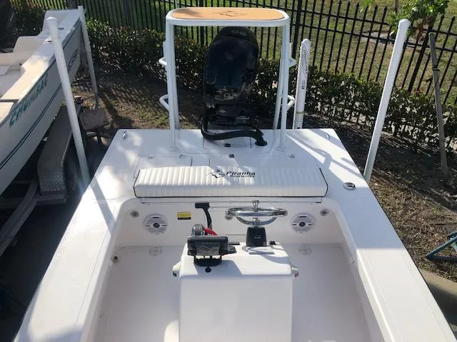 Slide: The Image of 2025 Piranha Alvo F1700 boat, white deck, steering console, outdoor setting. - 17