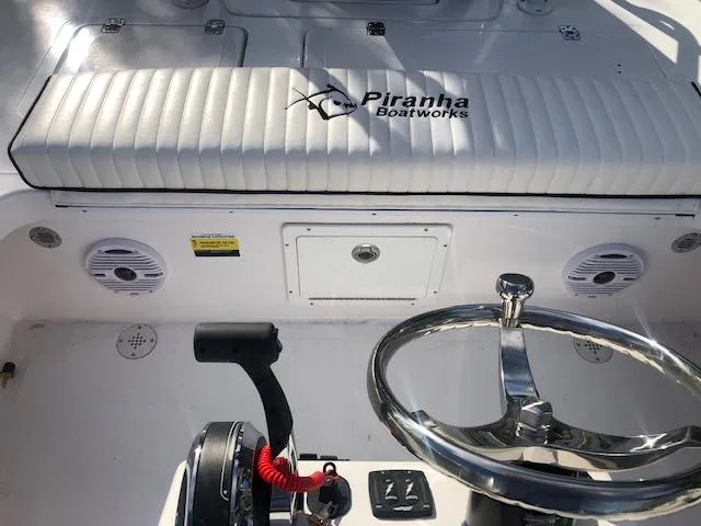 Slide: The Image of Steering console of 2025 Piranha Alvo F1700 boat with branded seating and controls. - 18
