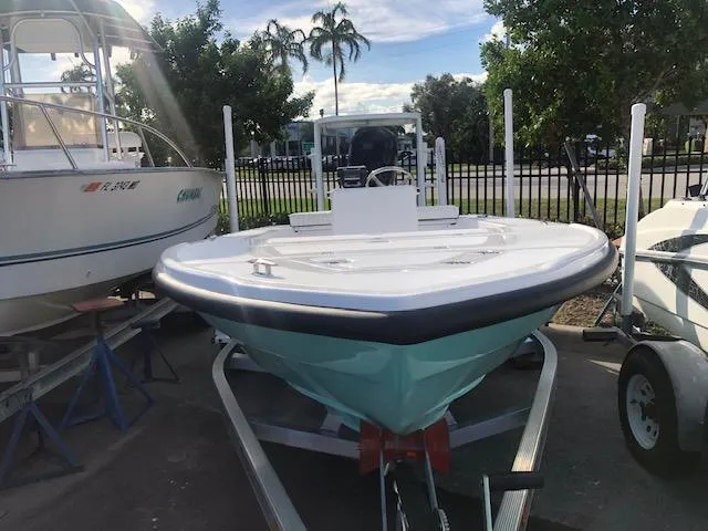 Slide: The Image of 2025 Piranha Alvo F1700 boat on trailer, parked outdoors with palm trees in background. - 2