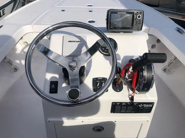 Slide: The Image of Steering console of 2025 Piranha Alvo F1700 boat with Mercury controls and navigation system. - 8