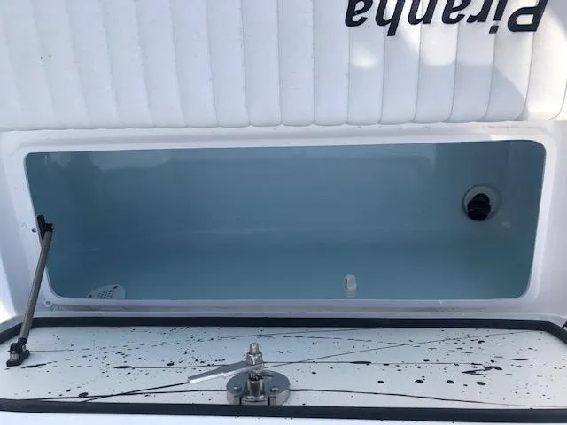 Slide: The Image of Open storage compartment of 2025 Piranha Alvo F1700 boat, featuring a clean interior. - 9