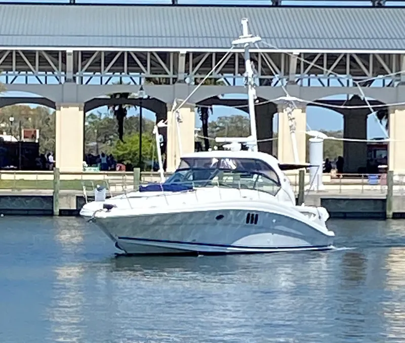 The Image of 2006 Sea Ray 44 Sundancer yacht docked near a marina. - 0