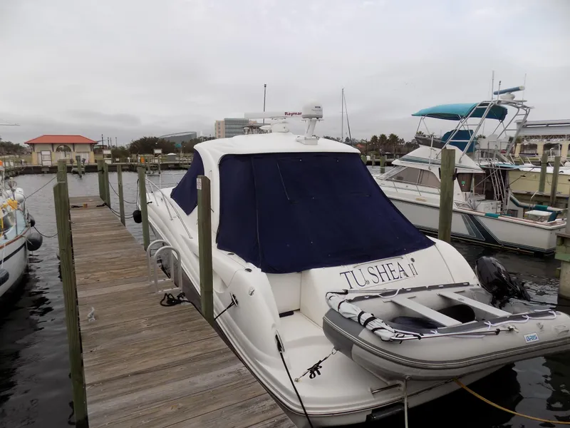 Slide: The Image of 2006 Sea Ray 44 Sundancer docked with a dinghy on the stern. - 11