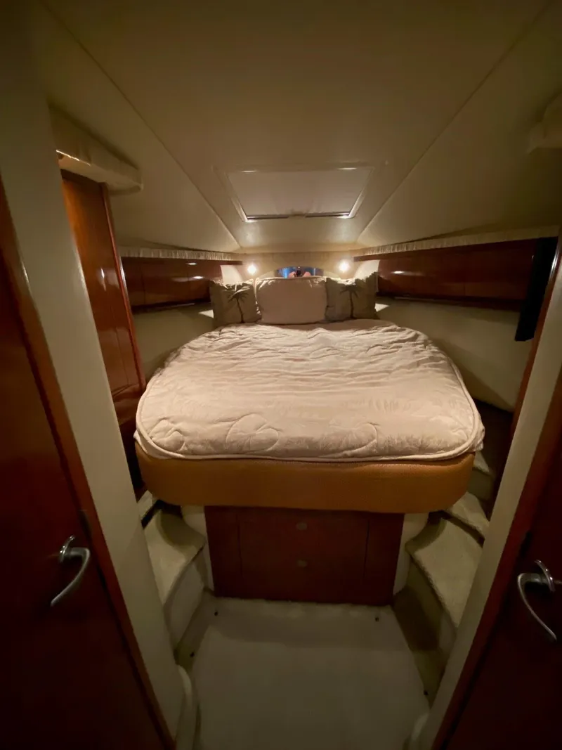 Slide: The Image of 2006 Sea Ray 44 Sundancer cabin with cozy bed and ambient lighting. - 16