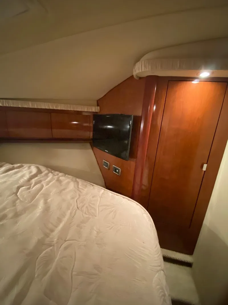 Slide: The Image of Interior cabin of 2006 Sea Ray 44 Sundancer yacht with wood paneling and bed. - 17