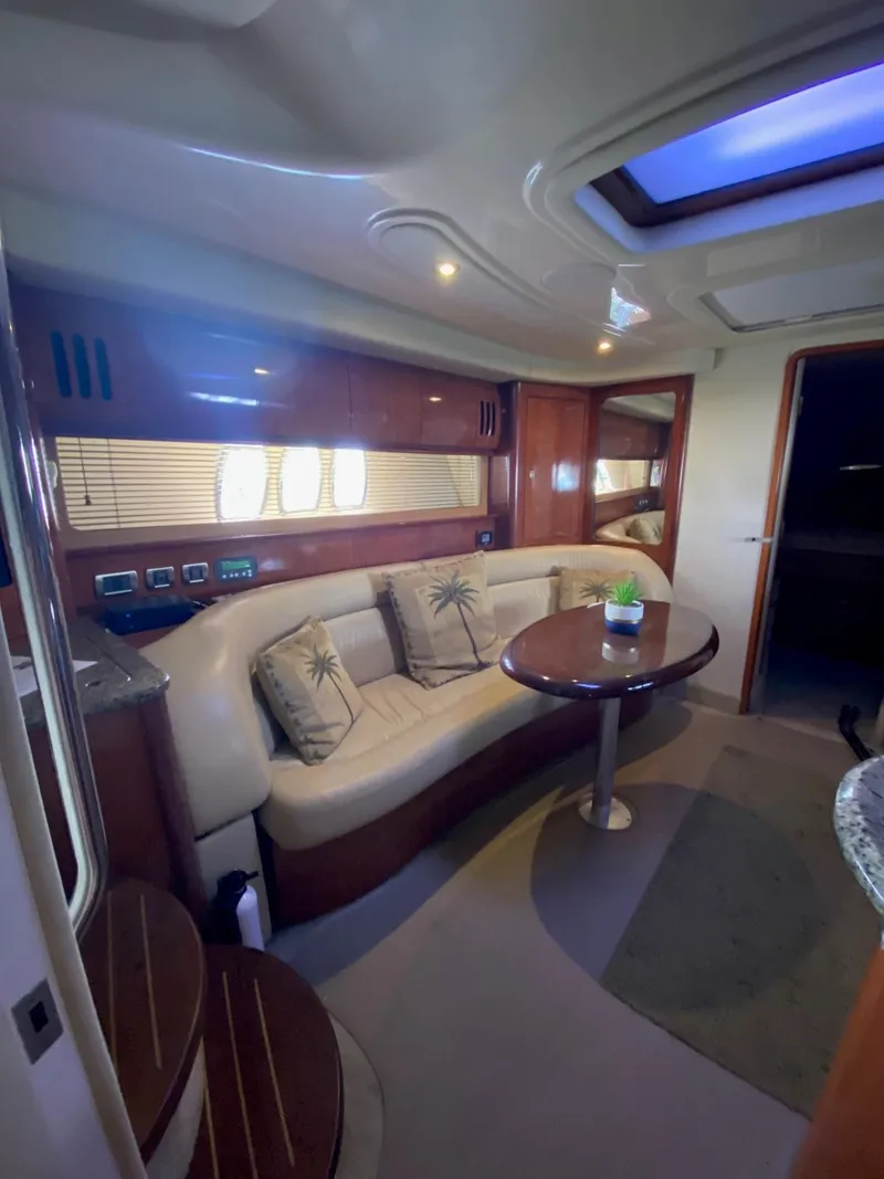 Slide: The Image of Interior of 2006 Sea Ray 44 Sundancer yacht with plush seating and elegant wood finishes. - 19
