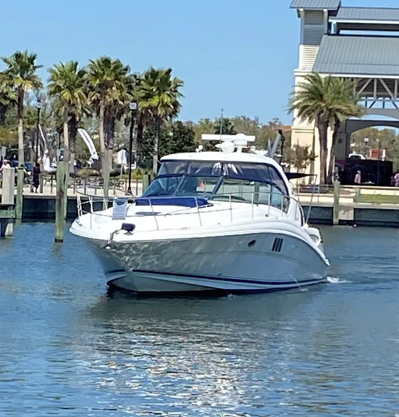 Slide: The Image of 2006 Sea Ray 44 Sundancer yacht cruising in a marina. - 2