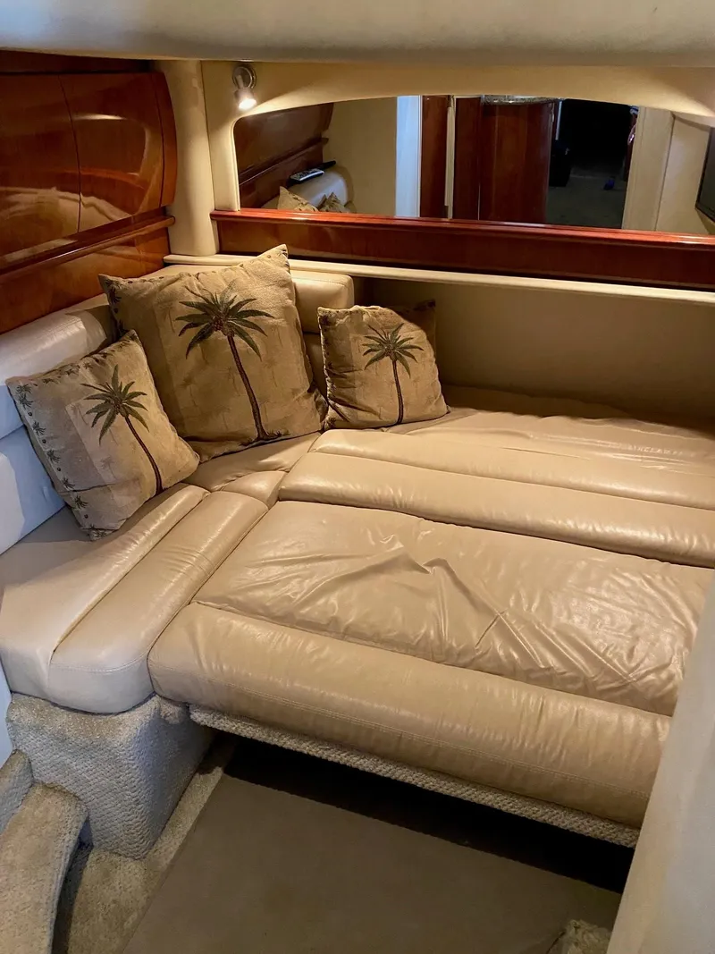 Slide: The Image of Interior of 2006 Sea Ray 44 Sundancer with beige leather seating and palm tree pillows. - 20