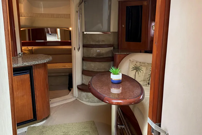 Slide: The Image of Interior of 2006 Sea Ray 44 Sundancer yacht with cozy seating and elegant wooden finishes. - 28