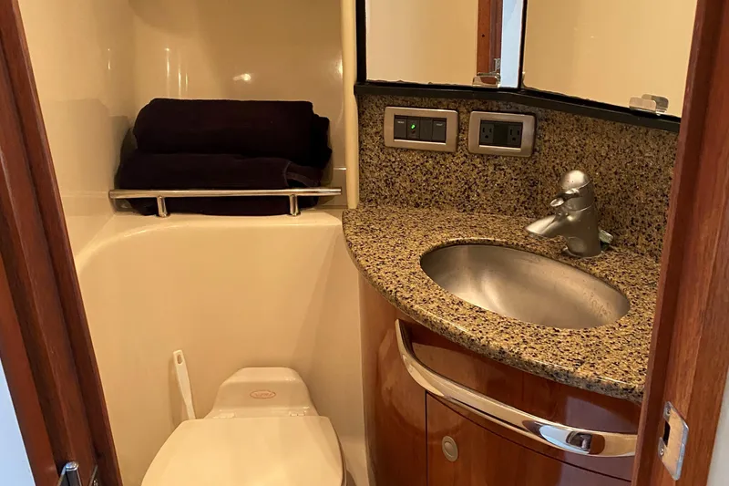 Slide: The Image of 2006 Sea Ray 44 Sundancer bathroom with granite countertop and stainless steel sink. - 29