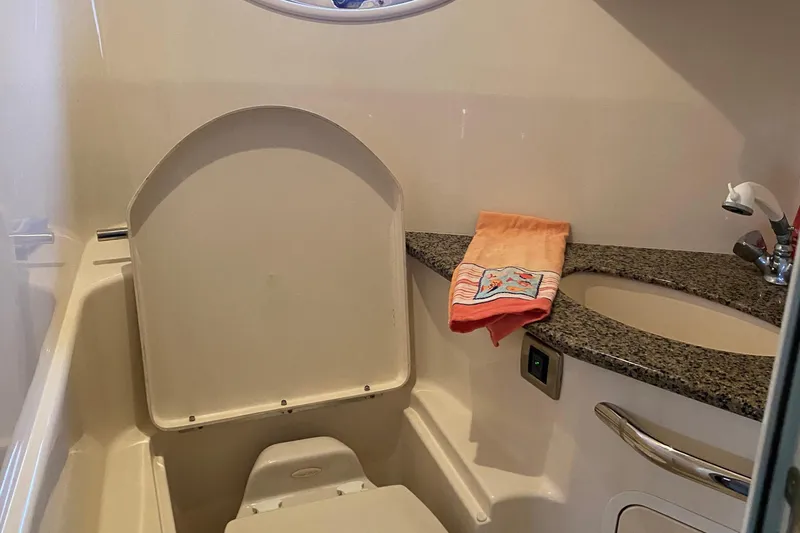 Slide: The Image of 2006 Sea Ray 44 Sundancer bathroom with toilet, sink, and granite countertop. - 30