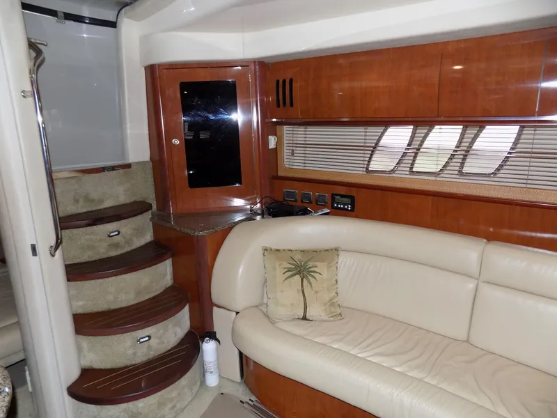 Slide: The Image of Interior of 2006 Sea Ray 44 Sundancer with leather seating and wooden cabinetry. - 33