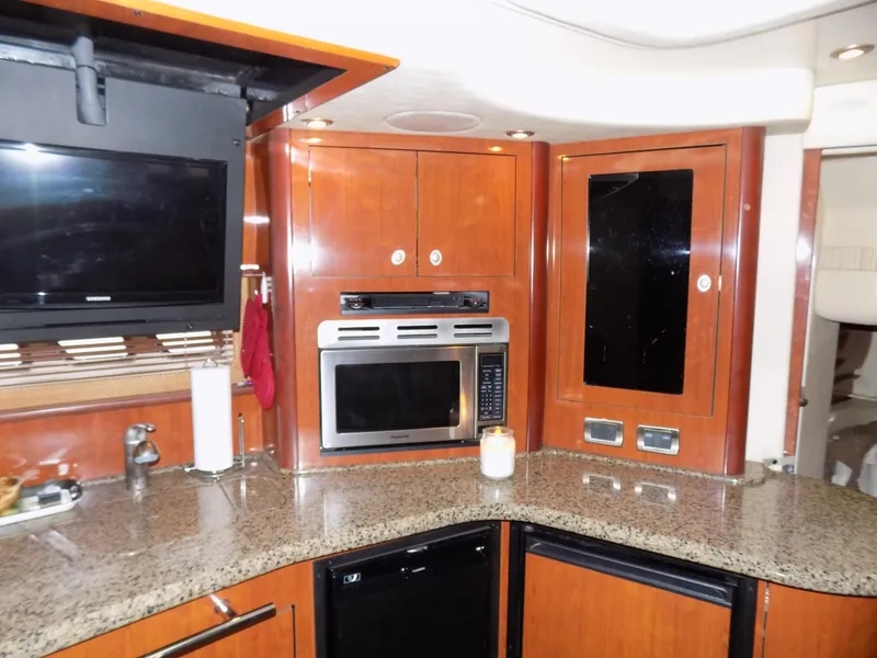 Slide: The Image of 2006 Sea Ray 44 Sundancer kitchen with granite countertops and modern appliances. - 35