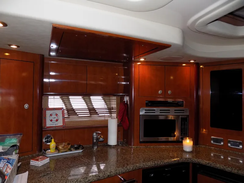 Slide: The Image of Luxurious kitchen area in 2006 Sea Ray 44 Sundancer yacht with granite countertops. - 36