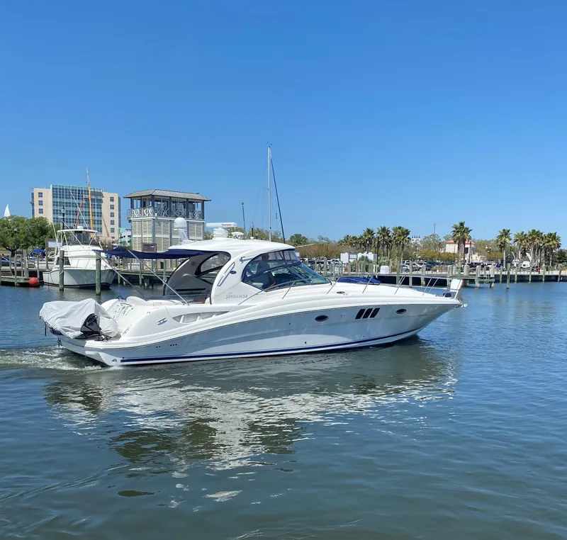 Slide: The Image of 2006 Sea Ray 44 Sundancer yacht cruising in a marina. - 4