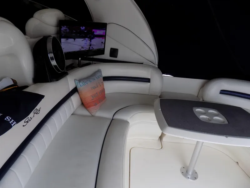 Slide: The Image of Interior of 2006 Sea Ray 44 Sundancer with white seating and a TV. - 43