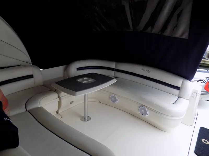 Slide: The Image of 2006 Sea Ray 44 Sundancer yacht interior seating area with table. - 44